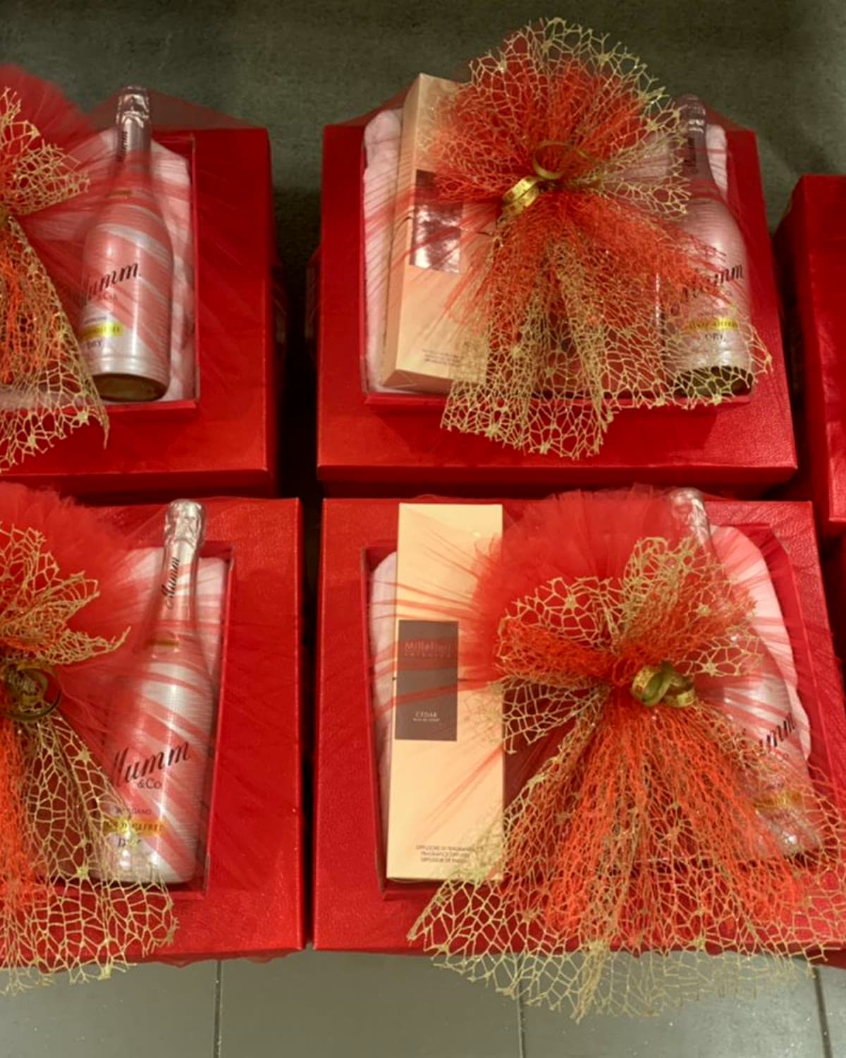 A corporate run of red hampers, wrapped and bowed