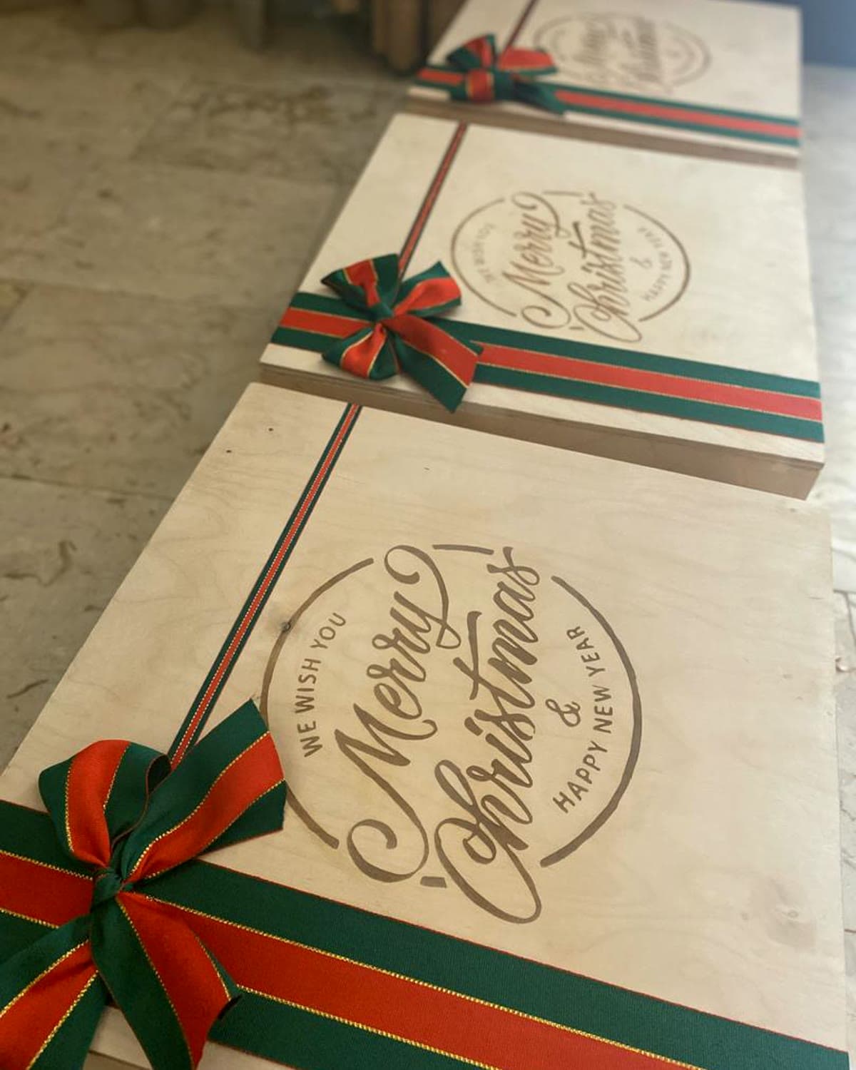 Wooden gift boxes engraved in-house, ribboned for a past commission