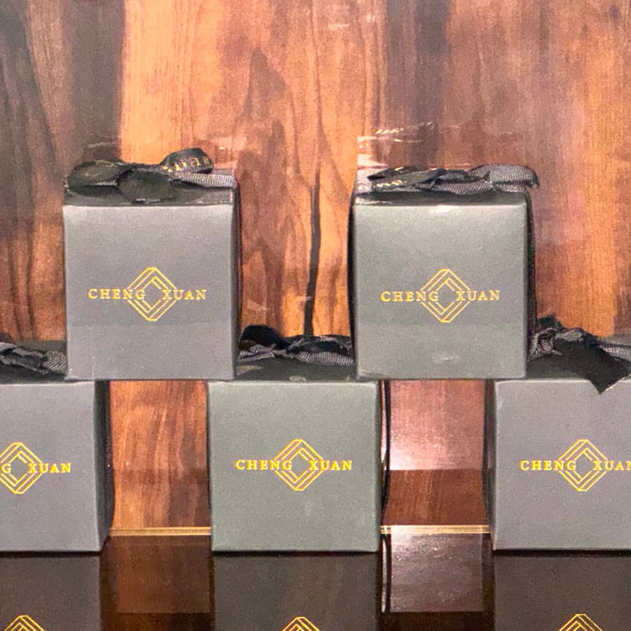 Stacked candle boxes on a walnut shelf