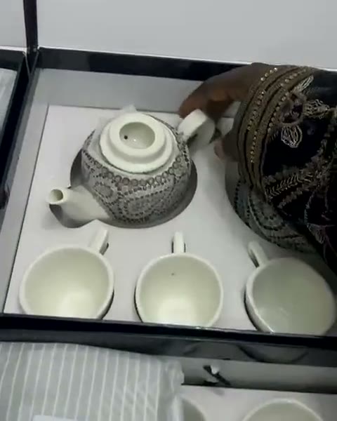 A hand-painted tea service being boxed in the atelier